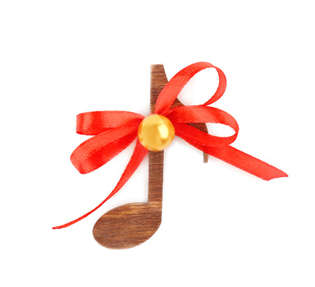 Christmas music concept. Decorative note with bow, isolated on white backgroundの写真素材