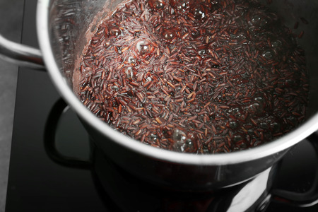 Stewpot with boiling rice in kitchenの写真素材