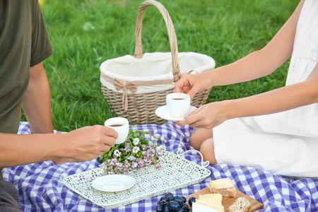 Couple in love drinking coffee on picnicの写真素材