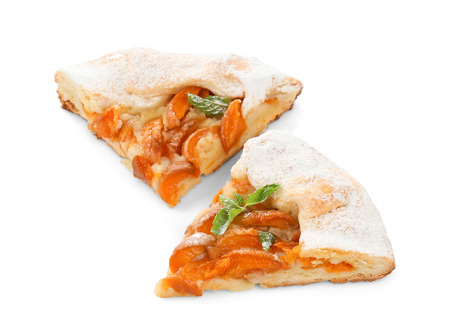 Pieces of tasty apricot cake on white backgroundの写真素材