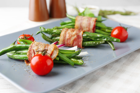 Plate with delicious bacon-wrapped green beans, closeupの写真素材