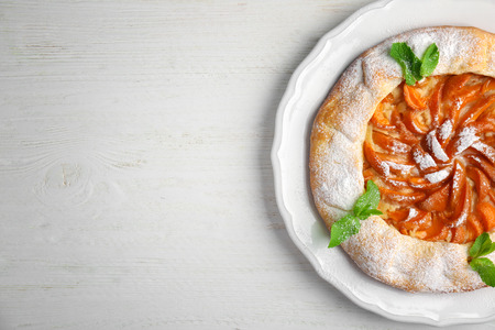 Delicious apricot cake on wooden backgroundの写真素材