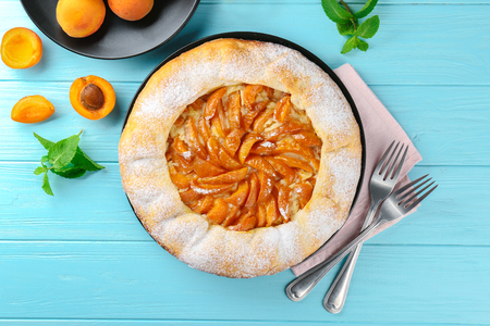 Delicious apricot cake on wooden backgroundの写真素材