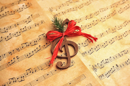 Wooden treble clef on music sheets. Christmas songs conceptの写真素材