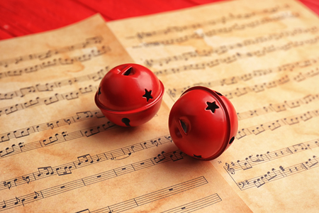 Decorative bells on music sheets. Christmas songs conceptの写真素材
