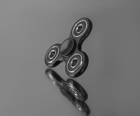 Modern spinner on mirror backgroundの写真素材