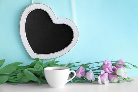 Composition with aromatic morning coffee and beautiful flowers on tableの写真素材