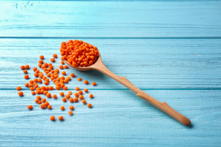Spoon with healthy lentils on wooden backgroundの写真素材