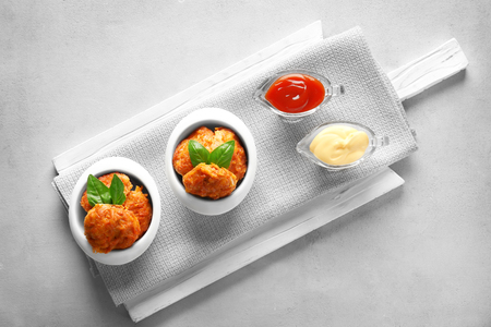 Composition with tasty sausage balls on light tableの写真素材
