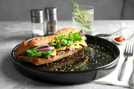 Plate with delicious steak sandwich on tableの写真素材
