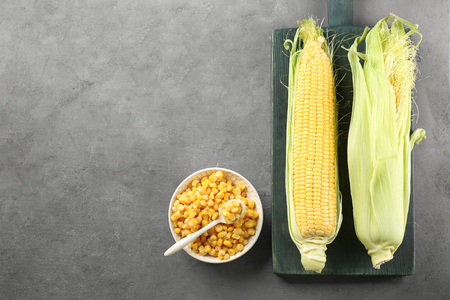 Corn kernels and cobs on grey backgroundの写真素材