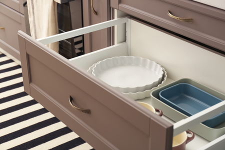 Set of ceramic dishes in kitchen drawer