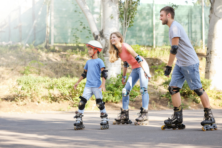 Family rollerskating in parkの写真素材