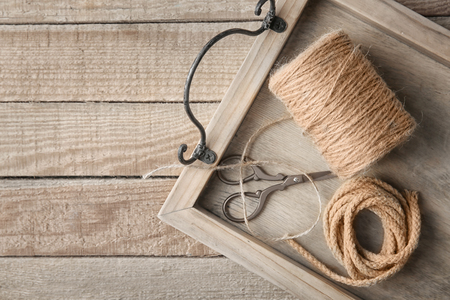 Tray with hank of hemp twine and rope on wooden backgroundの写真素材
