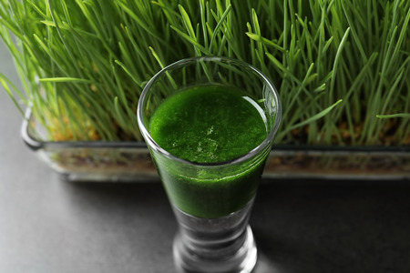Shot of healthy wheat grass juice, closeup