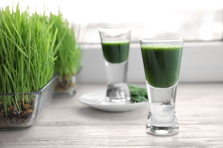 Shot of wheat grass juice on window sillの写真素材