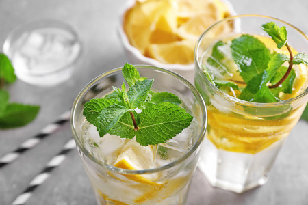 Glasses of cocktail with mint and lemon on tableの写真素材
