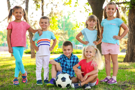 Cute little children with ball in parkの写真素材