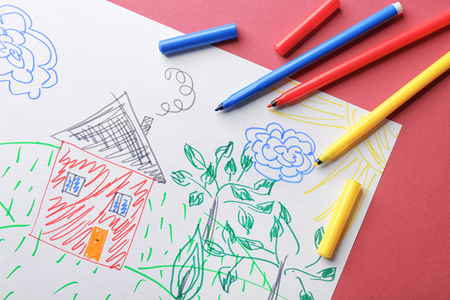 Child's drawing of house and trees on color background, closeupの写真素材