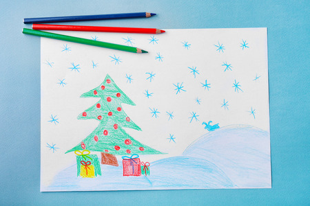 Child's drawing of Christmas tree with presents on grey backgroundの写真素材