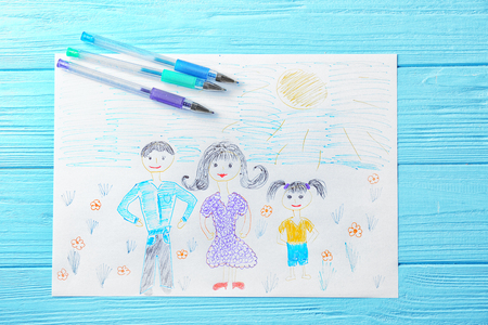 Child's drawing of family on blue backgroundの写真素材