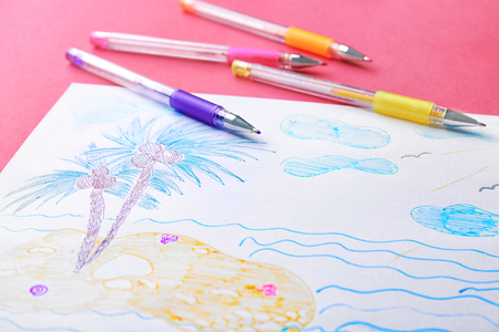 Child's drawing of island with palm trees on color background, closeupの写真素材