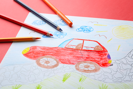 Child's drawing of red car on color background, closeupの写真素材