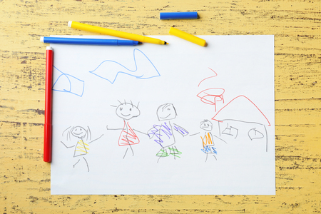 Child's drawing of family on yellow backgroundの写真素材