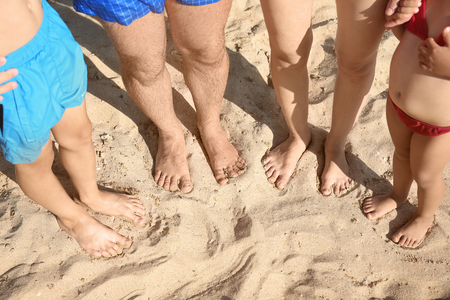 Legs of family resting at sea resortの写真素材