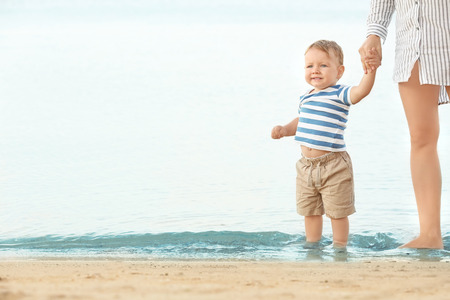 Happy mother with little son on beachの写真素材
