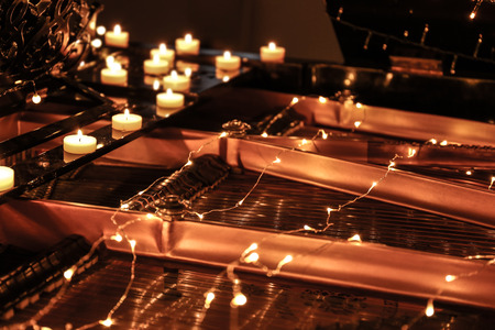 Piano with Christmas lights and candles, closeupの写真素材