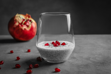 Glass with delicious chia seed pudding on tableの写真素材