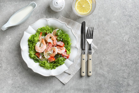 Plate with fresh tasty shrimp salad on tableの写真素材