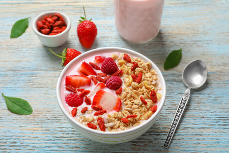 Tasty breakfast with goji berries in bowl on tableの写真素材