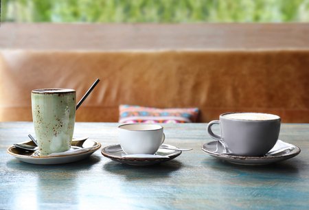 Cups of coffee on table in cafeの写真素材