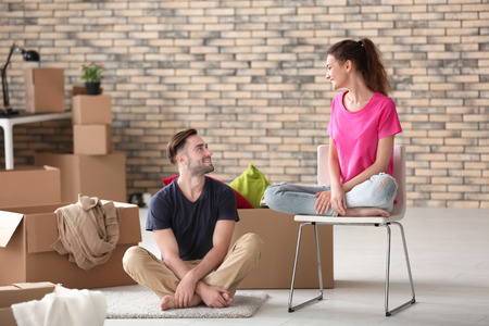 Young couple with moving boxes at new homeの写真素材