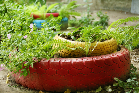 Old tires used as flowerbed outdoorsの写真素材