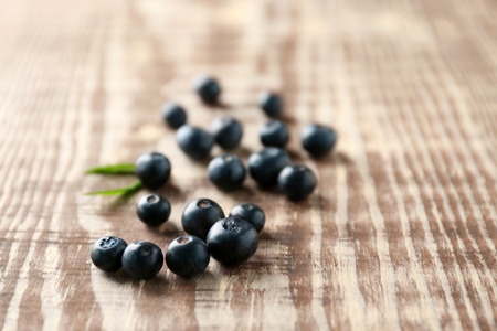 Fresh acai berries on wooden tableの写真素材
