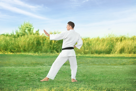 Young man practicing karate outdoorsの写真素材