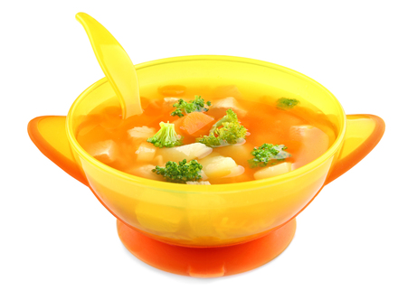 Plastic bowl with soup for baby on white backgroundの写真素材