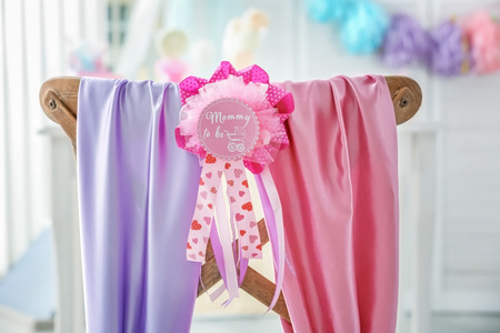 Decorated chair with text MOMMY TO BE on card indoorsの写真素材