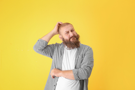 Emotional mature man on yellow backgroundの写真素材
