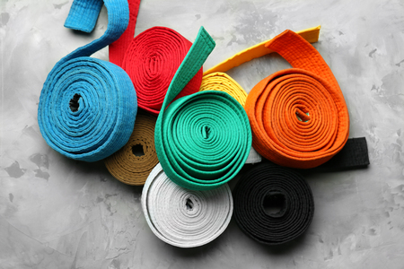 Colorful karate belts on grey backgroundの写真素材