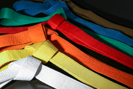 Colorful karate belts on dark background, closeupの写真素材