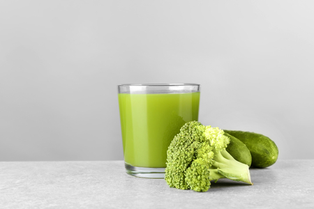 Green vegetable juice in glass on tableの写真素材