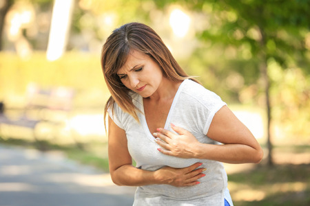 Mature woman having heartache outdoors