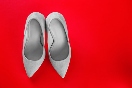 Female stylish shoes on color backgroundの写真素材