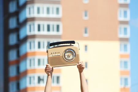 Woman holding radio, outdoorsの写真素材