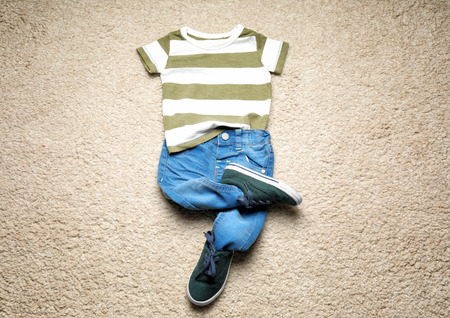 Composition with fashionable children clothes on carpetの写真素材