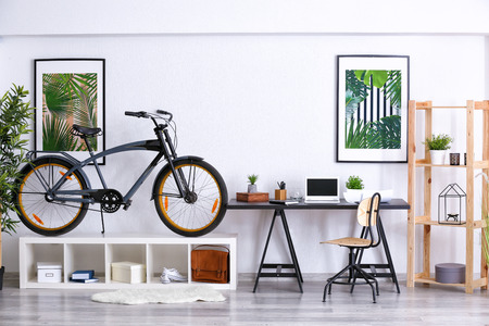Modern room interior with bicycle and workplaceの写真素材